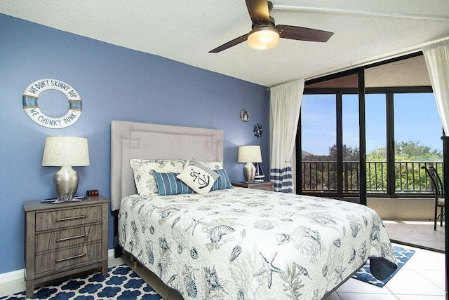 tiled bedroom featuring expansive windows, baseboards, ceiling fan, and access to outside