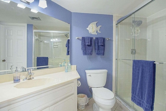 full bathroom with toilet, a stall shower, vanity, and tile patterned flooring