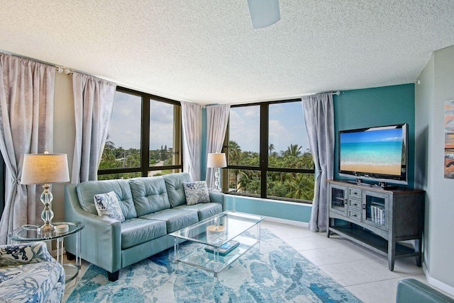 living room featuring tile patterned floors, baseboards, and a textured ceiling