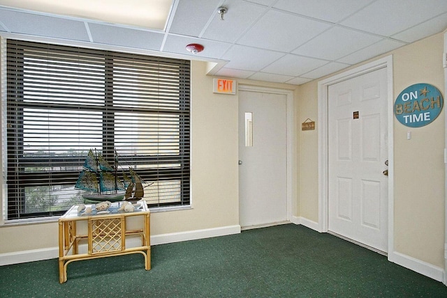 carpeted entrance foyer with a healthy amount of sunlight, baseboards, and a paneled ceiling