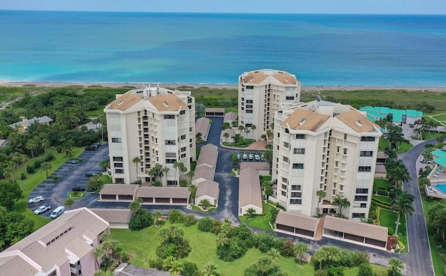 drone / aerial view featuring a beach view and a water view