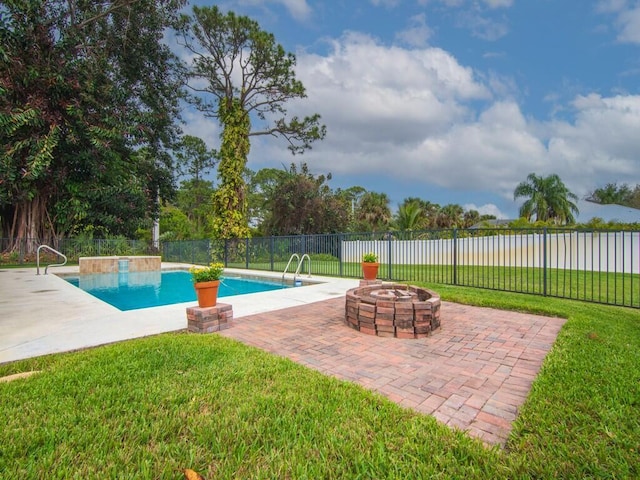 view of pool with a patio, a fenced backyard, an outdoor fire pit, a yard, and a fenced in pool