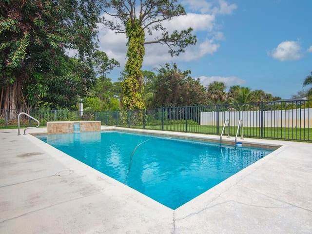 view of swimming pool featuring a patio area, fence, and a fenced in pool