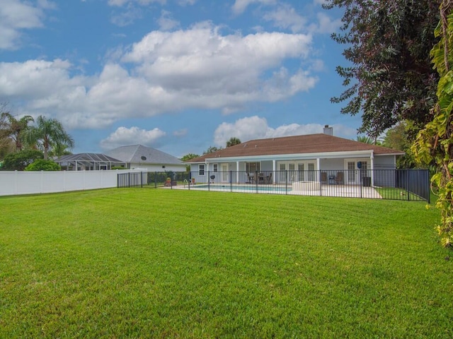 view of yard with a patio area, fence, and a fenced in pool