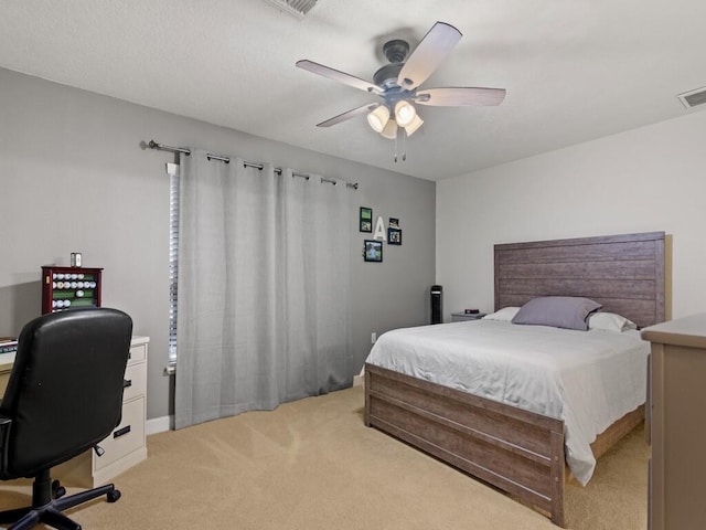 bedroom with visible vents, light colored carpet, and ceiling fan