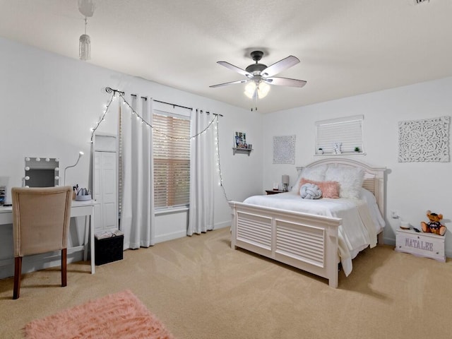 bedroom featuring a ceiling fan, baseboards, and carpet floors