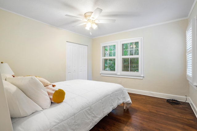 bedroom with multiple windows, wood finished floors, baseboards, and ornamental molding