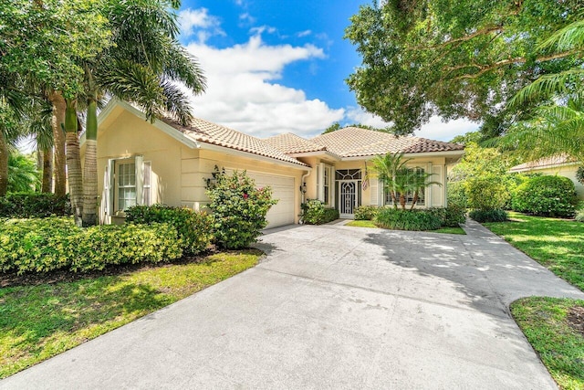 396 Kelsey Park Dr, Palm Beach Gardens, FL 33410 - mediterranean / spanish-style house with an attached garage, stucco siding, a tile roof, and concrete driveway