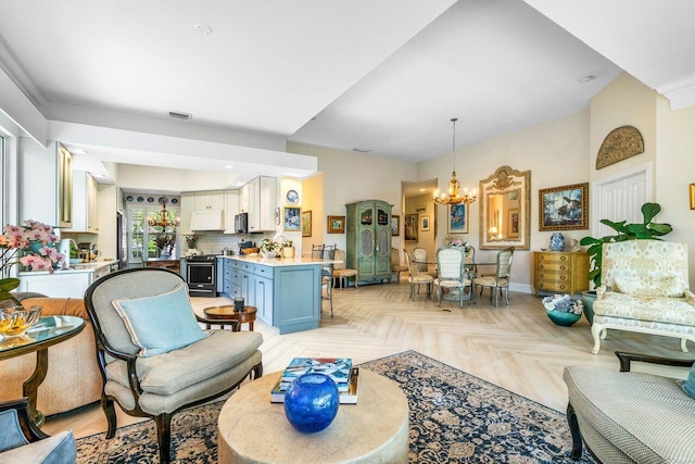 396 Kelsey Park Dr, Palm Beach Gardens, FL 33410 - living room with an inviting chandelier, baseboards, and visible vents