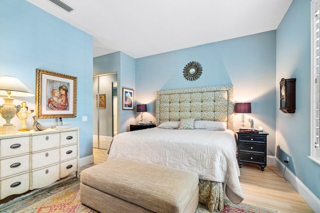 396 Kelsey Park Dr, Palm Beach Gardens, FL 33410 - bedroom with baseboards, visible vents, and light wood finished floors