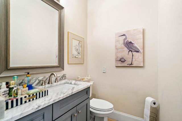 396 Kelsey Park Dr, Palm Beach Gardens, FL 33410 - bathroom with toilet, baseboards, and vanity