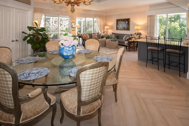 dining room with crown molding, a wealth of natural light, and a chandelier