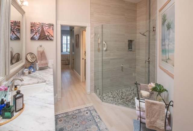 bathroom with double vanity and a shower stall