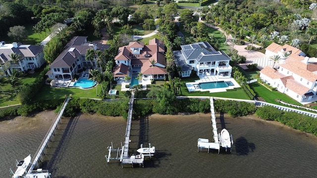 drone / aerial view featuring a residential view and a water view