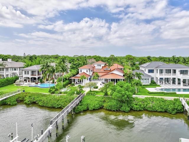 drone / aerial view featuring a residential view and a water view