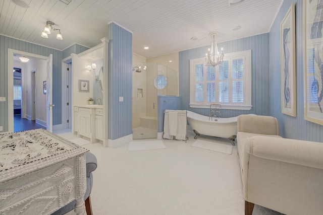 bedroom featuring ensuite bathroom, baseboards, and a chandelier