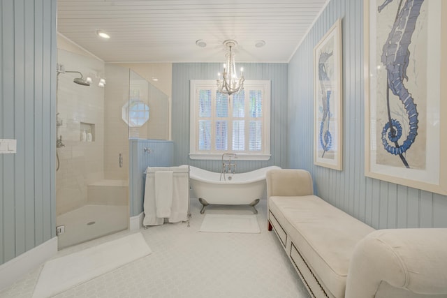 full bath with a freestanding tub, an inviting chandelier, and a shower stall