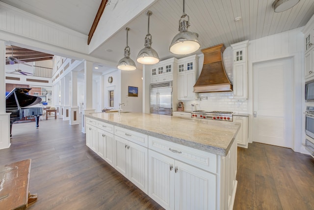 kitchen featuring dark wood-style floors, custom range hood, and built in refrigerator