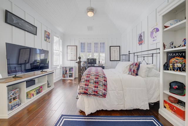 bedroom featuring lofted ceiling and hardwood / wood-style floors