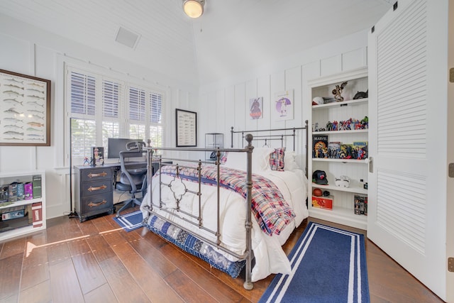 bedroom with visible vents and dark wood-style flooring