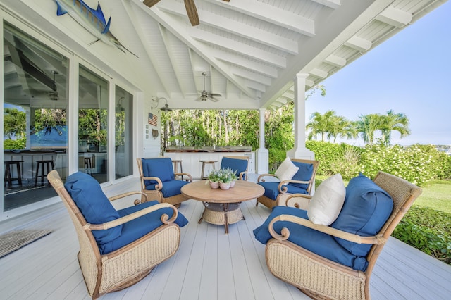 wooden deck with a ceiling fan and an outdoor living space