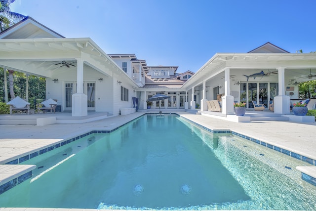 outdoor pool with a patio and ceiling fan