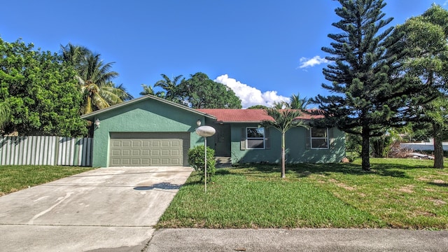 single story home with a front lawn, fence, stucco siding, driveway, and an attached garage