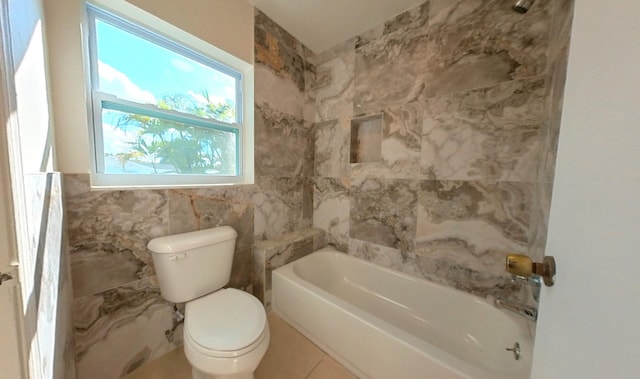 full bath with toilet, tile walls, and washtub / shower combination