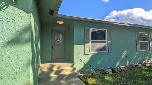 property entrance featuring stucco siding