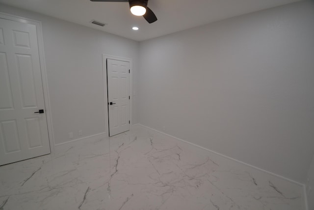 empty room featuring visible vents, marble finish floor, a ceiling fan, recessed lighting, and baseboards