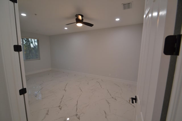 spare room featuring recessed lighting, visible vents, marble finish floor, and baseboards