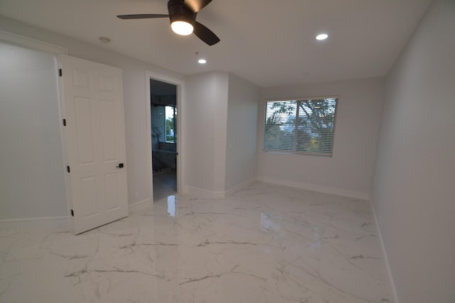 unfurnished room with recessed lighting, baseboards, marble finish floor, and ceiling fan