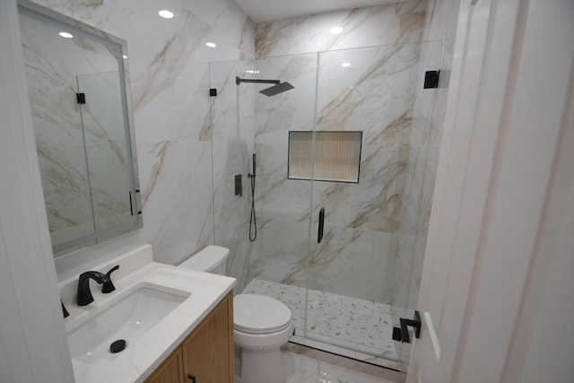 full bathroom featuring vanity, toilet, marble finish floor, and a marble finish shower