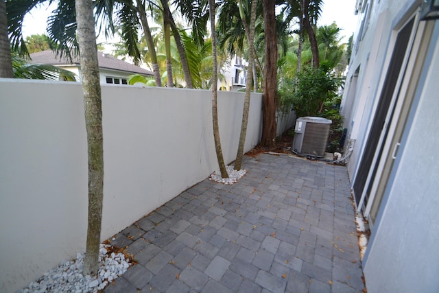 view of patio / terrace with central AC unit and a fenced backyard