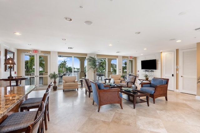 living area featuring recessed lighting, french doors, and visible vents