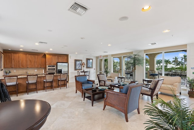 living area with recessed lighting and visible vents