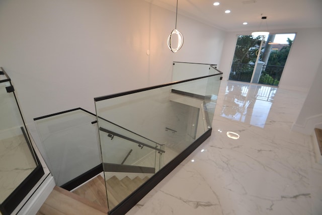 stairway featuring crown molding, recessed lighting, and marble finish floor