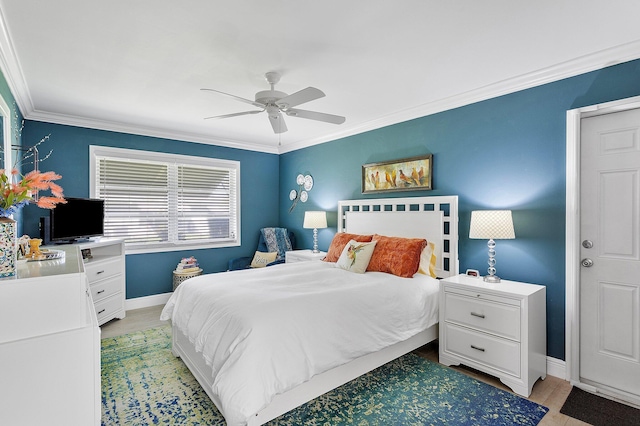 bedroom featuring a ceiling fan, baseboards, light wood-type flooring, and ornamental molding