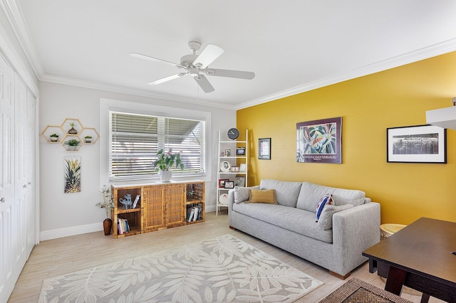 living area with a ceiling fan, wood finished floors, baseboards, and ornamental molding