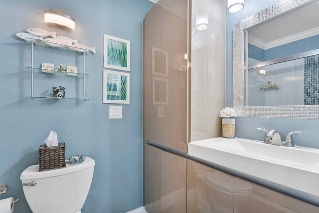 full bath featuring a shower stall, toilet, crown molding, and a sink