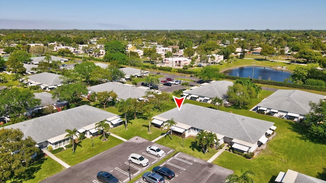 drone / aerial view featuring a residential view and a water view