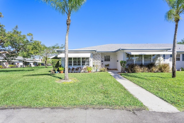 view of front of property featuring stucco siding and a front lawn