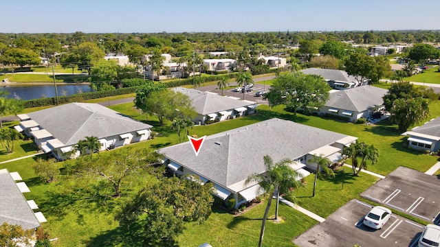 drone / aerial view featuring a residential view and a water view