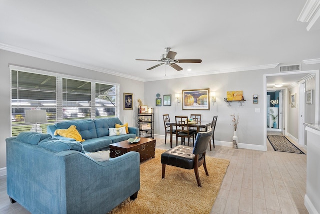 living area featuring visible vents, ornamental molding, light wood finished floors, baseboards, and ceiling fan