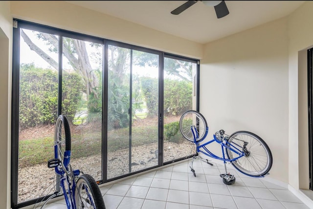 unfurnished sunroom with a ceiling fan