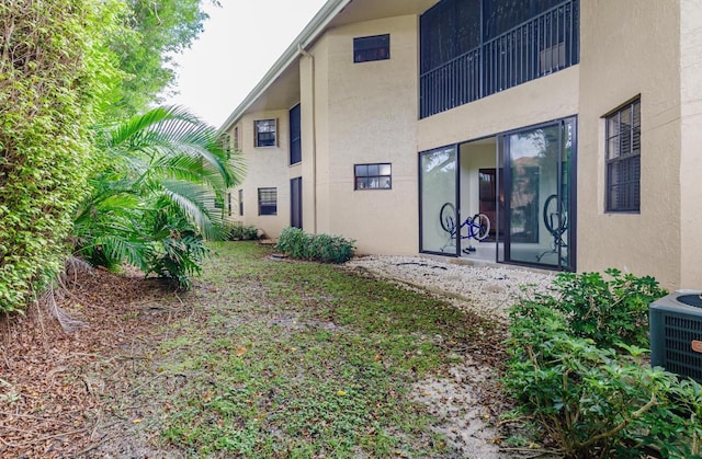 back of property featuring central air condition unit and stucco siding