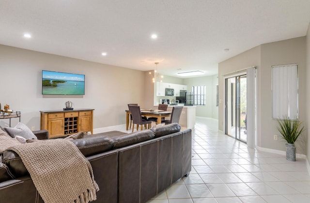 living room with light tile patterned flooring, recessed lighting, and baseboards