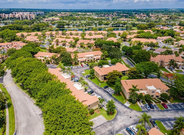 drone / aerial view with a residential view and a water view