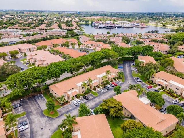 drone / aerial view featuring a residential view and a water view