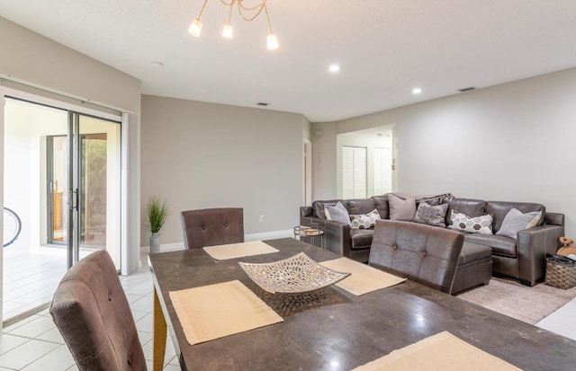 living area with light tile patterned floors, visible vents, recessed lighting, and baseboards